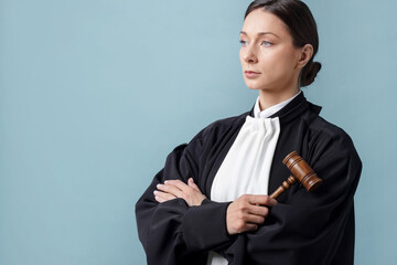 Judge with mallet on light blue background, space for text