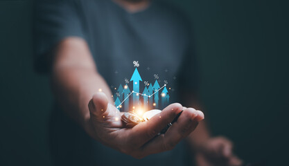 Business growth concept. Businessman 'hand holding heap of coins and arrow up with percentage symbol for financial increase interest rate or mortgage investment dividend. Saving money.