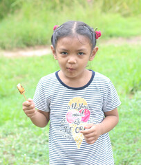 Portrait of asian cute little girl eating food