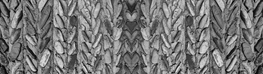 Fashionable stone wall background for designers, long banner. Natural mountain stones in facade and interior design.
