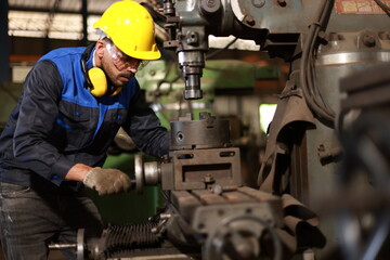 Factory male worker. Engineer man worker in plant production drilling at machine in smart factory...