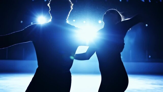 Dynamic Duo: A Silhouette of Graceful Figure Skaters on Ice Under Bright Lights