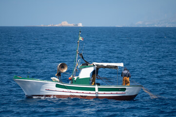 Boat trip from Trapani with view of fort, blue water and fisherman's boats, travel destination on...