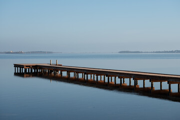 Obraz premium Morning stillness and mirror-quiet water at Stagnone of Marsala, lagoon and nature reserve near Marsala, Sicily, Italy, fisherman's boats
