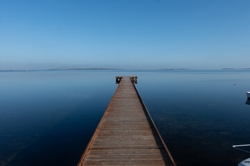 Obraz premium Morning stillness and mirror-quiet water at Stagnone of Marsala, lagoon and nature reserve near Marsala, Sicily, Italy, fisherman's boats