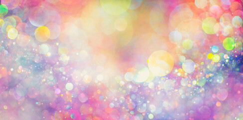 Pastel rainbow of sparkling glitter creating a mystical spectrum of colors. Dreamy or magical shimmering particles glowing in a blurry bokeh of lights. Blurred soft pastel colors abstract background.