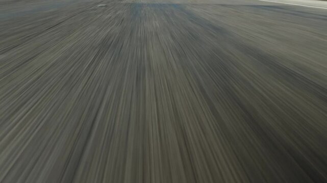 POV driving on asphalt road. Low angle.	