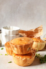 Tasty meat pot pies on light background