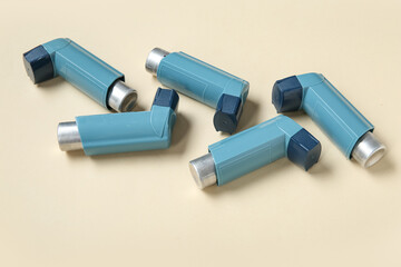 Asthma inhalers on beige background