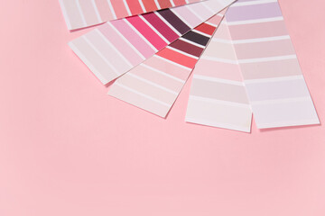 Naklejka premium Many color palettes on pink background