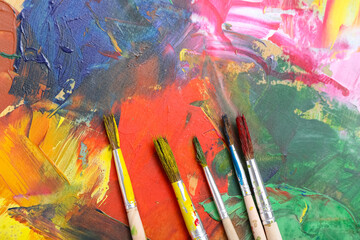 Artist's brushes on paint palette, closeup