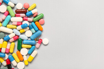 Different pills on grey background