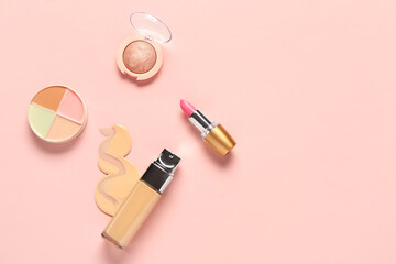 Bottle of makeup foundation with sample and cosmetic products on pink background