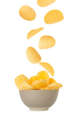 Tasty crispy potato chips falling into bowl on white background