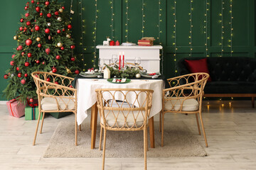 Festive table setting in stylish living room with Christmas tree and fireplace