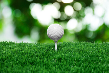Golf ball on green grass outdoors, closeup