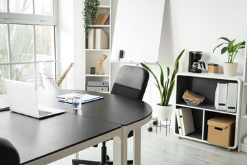 Interior of modern office with table prepared for meeting