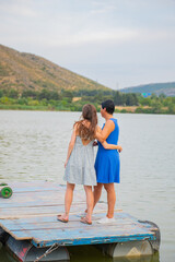 Two girls stand on a pier by a lake in Georgia