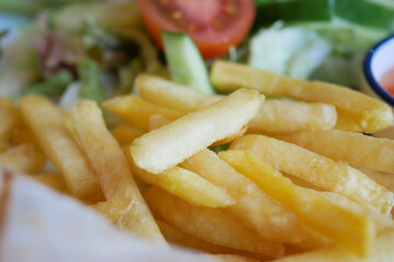 Crispy golden fries served with fresh salad and vegetables