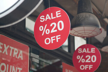 Discount signs announcing sale at local store entrance