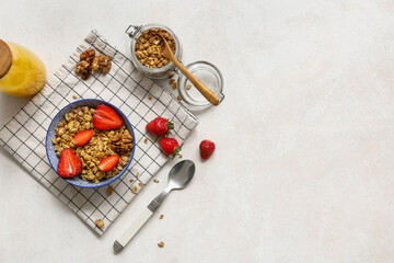Napkin, bowl with tasty granola and berries on white background