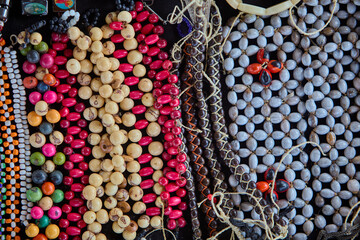 organic Amazonian crafts adorned with huayruro seeds(Ormosia coccinea)  . Symbols of luck, protection, and the deep connection between nature and culture in the rainforest. Iquitos Peru.