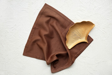 Brown napkin with plate on white grunge background