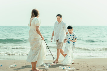 Family carry a bag to collect trash on the beach and clean up the dirty sea while collecting reusable plastic bottles.