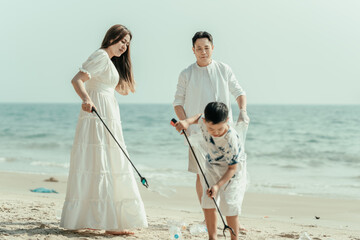 Family carry a bag to collect trash on the beach and clean up the dirty sea while collecting reusable plastic bottles.