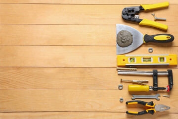 Trowel with cement and construction tools on wooden background
