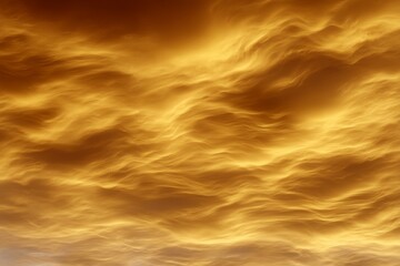 Golden sunset clouds with dramatic swirling patterns in the evening sky