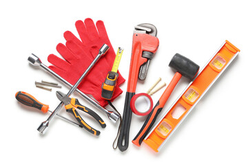 Gloves and construction tools on white background