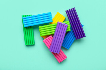 Heap of colorful plasticine on turquoise background