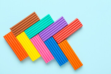 Many colorful plasticine on blue background
