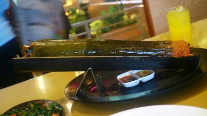 Grilled fish in bamboo with spices.