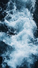 Obraz premium Aerial perspective of the turbulent ocean surface featuring churning white foam trails