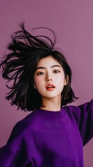 A young woman with short, dark hair and a purple sweatshirt.