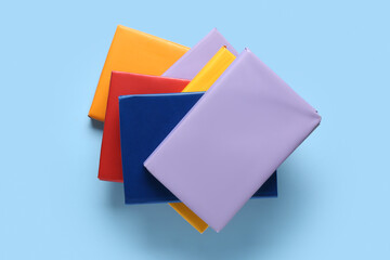 Many colorful books on blue background