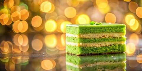 Colorful green cake slice on a reflective surface