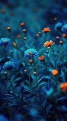 Vibrant blue and orange wildflowers bloom in a lush, dark teal field, softly blurred for a dreamy effect