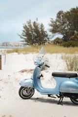 Selbstklebende Fototapeten blue scooter on the beach © Victoria