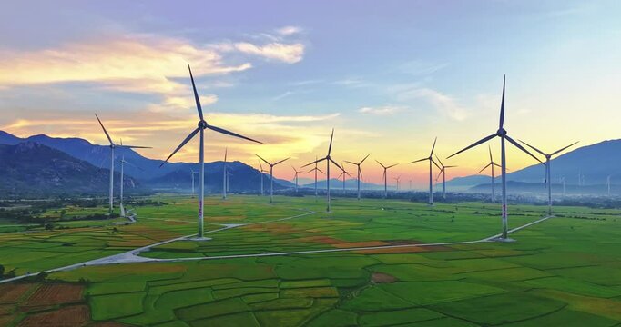 Panoramic view of wind farm or wind park. Wind turbines generating electricity on rice field at Phan Rang, Ninh Thuan, Vietnam. Clean energy concept