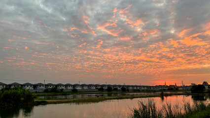 Scenic View of a Quiet Village at Dusk, Gently Bathed in the Warm Golden Light of the Setting Sun