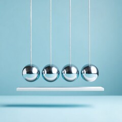 Modern Newtons Cradle with Polished Metal Spheres on Minimalist Stand Demonstrating Momentum Transfer and Systematic Thinking for Business Innovation