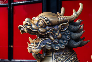 Golden Dragon Sculpture with Red Background