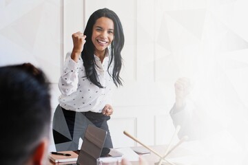 Businesswoman motivating her team members in a meeting