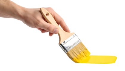 Hand with paintbrush adding bright yellow paint isolated on transparent background