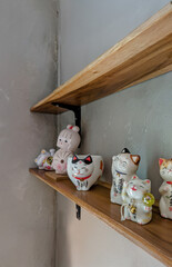 A charming display of various Maneki Neko lucky cat figurines and other Japanese-inspired ceramic...