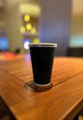 Black coffee cup on a wooden table