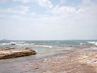 Rocky Japanese Coastline with Breakwaters and Blue Sky